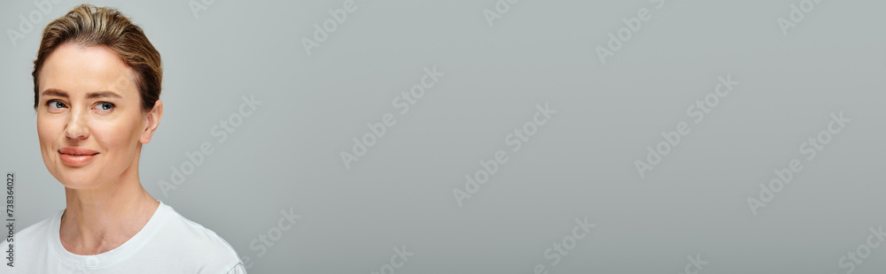cheerful pretty woman with contact lenses posing on gray backdrop and looking away, banner cheerful pretty woman with contact lenses posing on gray backdrop and looking away, banner
