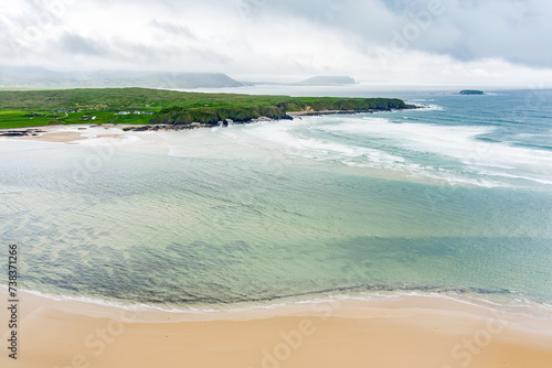 Five Finger Strand, one of the most famous beaches in Inishowen known for its pristine sand and rocky coastline with some of the highest sand dunes in Europe, county Donegal, Ireland. photo
