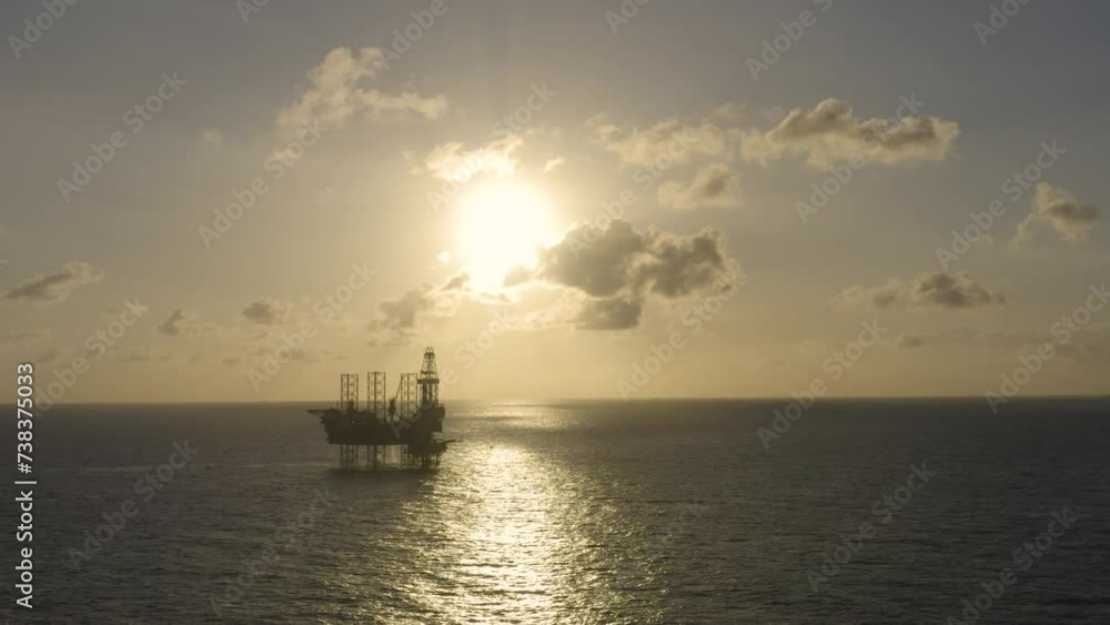 Aerial view of silhouette offshore jack up drilling rig during sunset - oil and gas industry
Aerial view of silhouette offshore jack up drilling rig during sunset - oil and gas industry