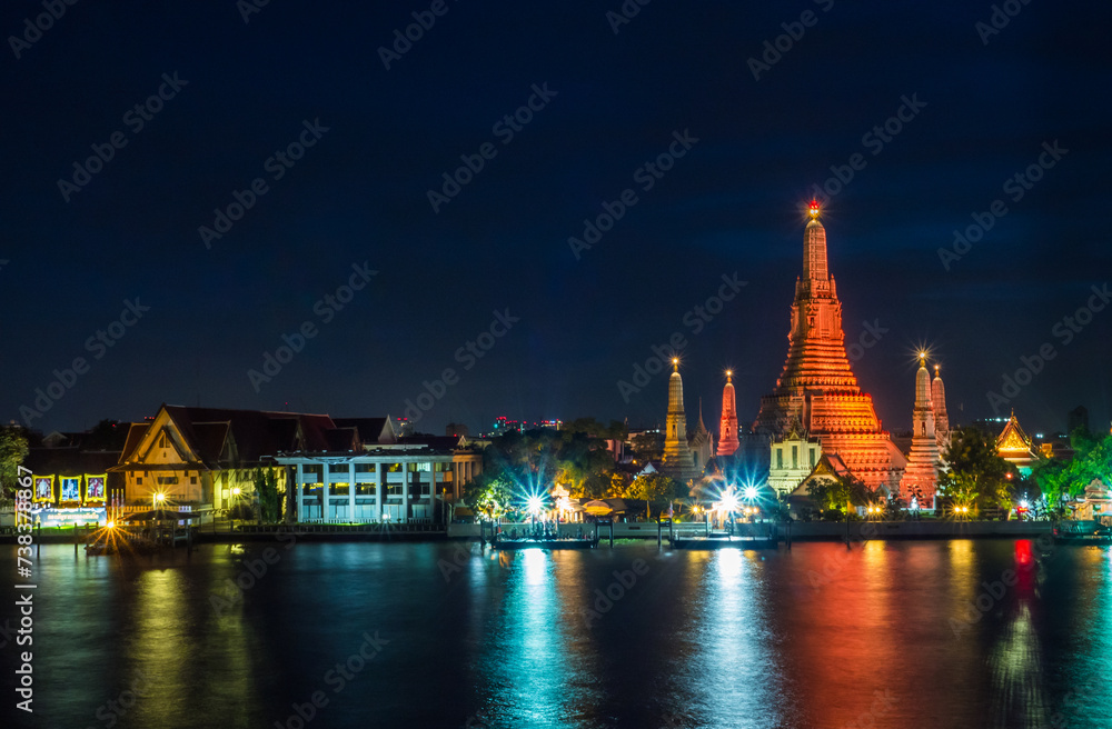 The ancient famous temple, Wat Arun Ratchawararam, light up in the night, Bangkok, Thailand.