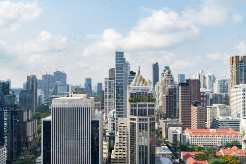 Closeup image of Bangkok cityscape. Modern cityscape surrounded with architectural building with day light and blue sky. Side view. Business background. Day light. Ornamented. © Summit Art Creations