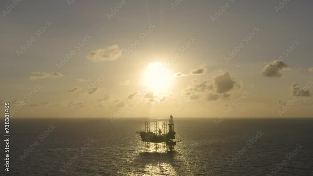 Aerial view of silhouette offshore jack up drilling rig during sunset - oil and gas industry
Aerial view of silhouette offshore jack up drilling rig during sunset - oil and gas industry