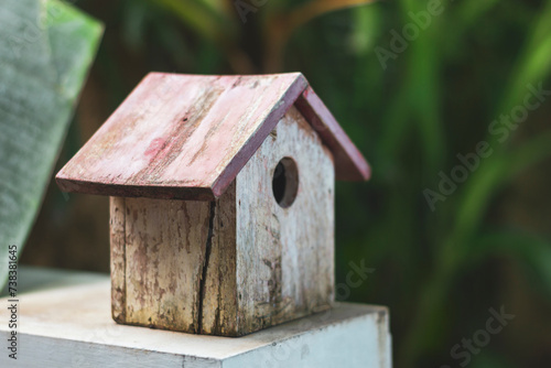 Old wooden bird house on a fence for decoration