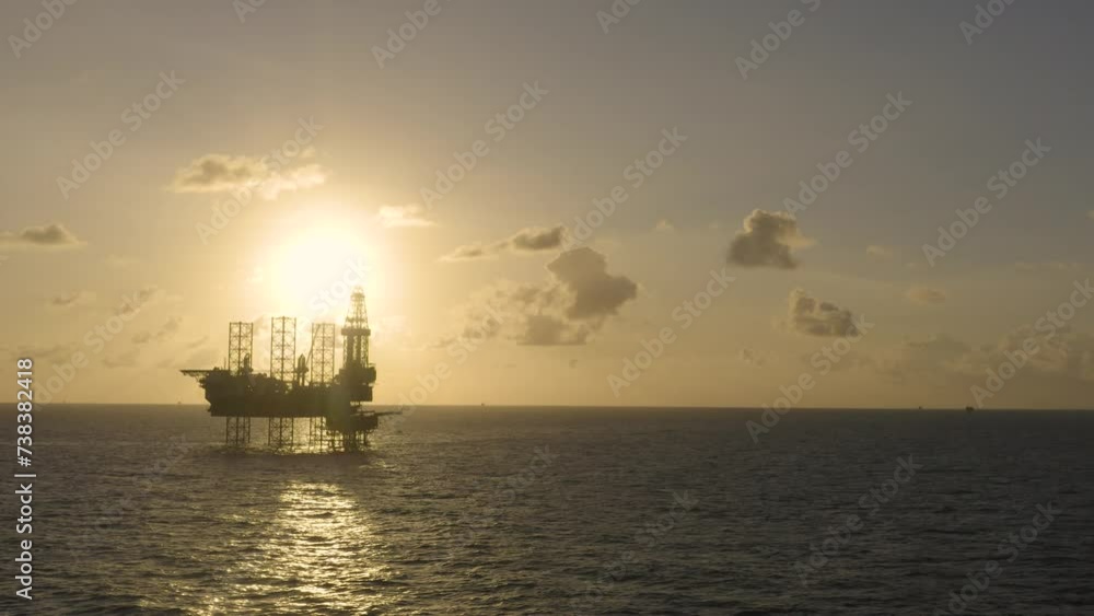 Aerial view of silhouette offshore jack up drilling rig during sunset - oil and gas industry
Aerial view of silhouette offshore jack up drilling rig during sunset - oil and gas industry