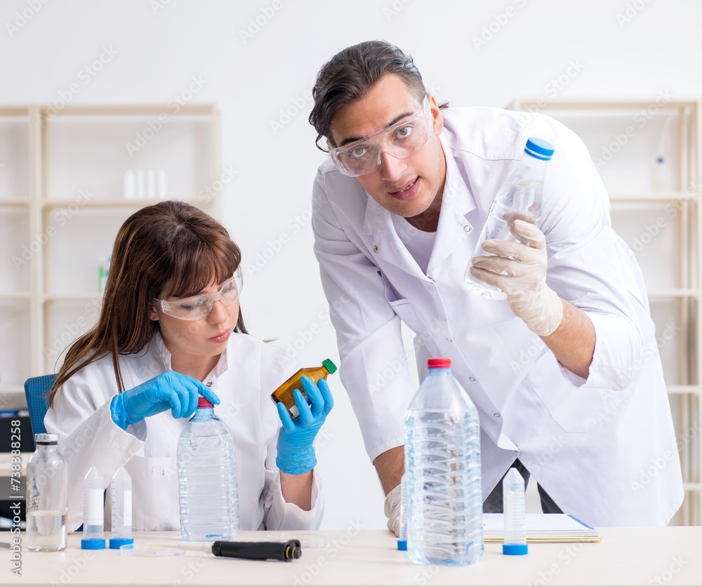 Two chemists working in the lab Two chemists working in the lab