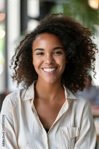 Headshot portrait of happy smiling mixed race female employee student posing at the university offices. Casual young black female in good mood