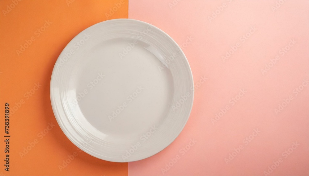Empty wite plate on orange and pink pastel background. Top view with copy space Empty wite plate on orange and pink pastel background. Top view with copy space