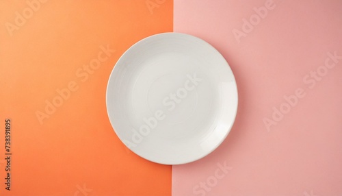 Empty wite plate on orange and pink pastel background. Top view with copy space.  photo