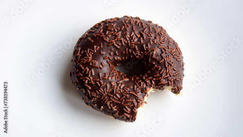 Ciambella, donut of yeast pastry with chocolate gassed on white background isolated and alone photo