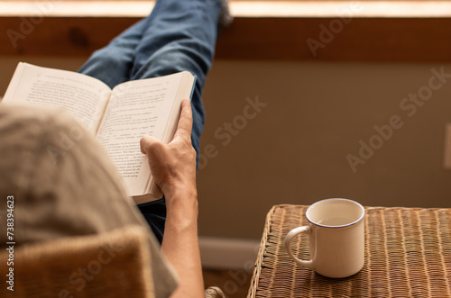 Man reading relaxing at home 