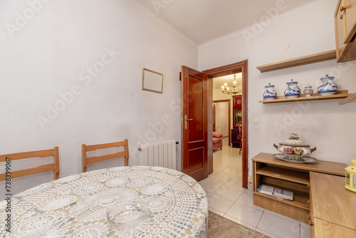 A small living room with a stretcher table with a crochet bantel in a house with, old-fashioned, wooden furniture photo