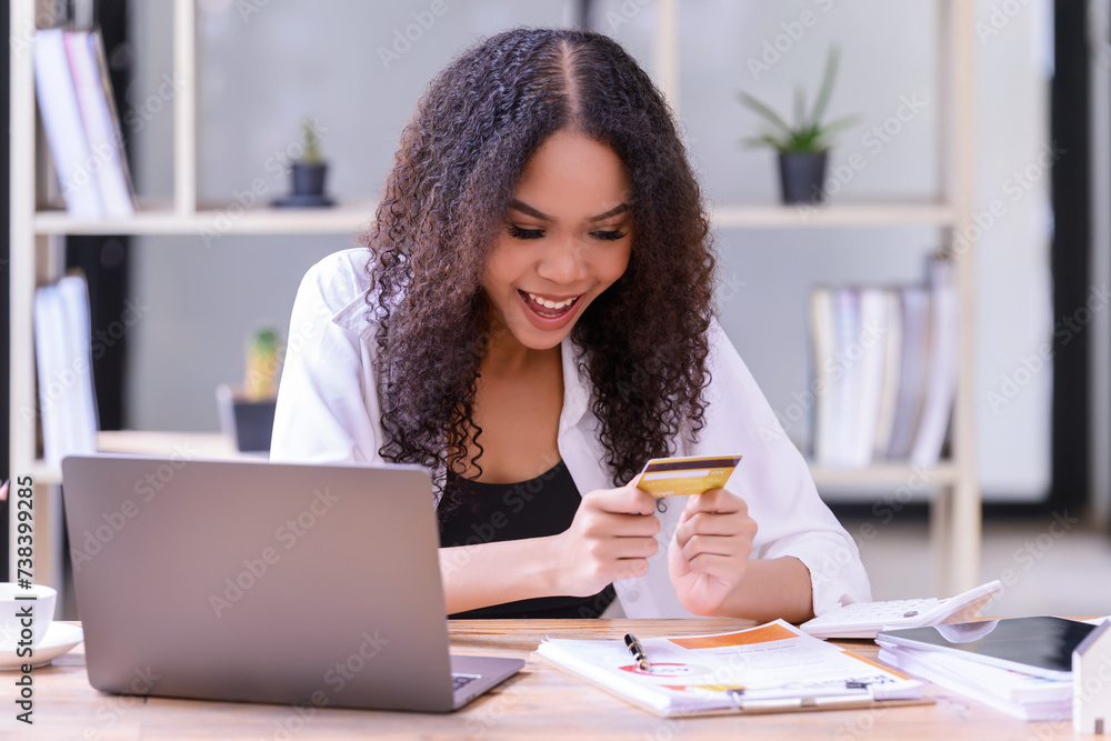 A young female buys things online or pays her bills by credit card through your computer. A young female buys things online or pays her bills by credit card through your computer.