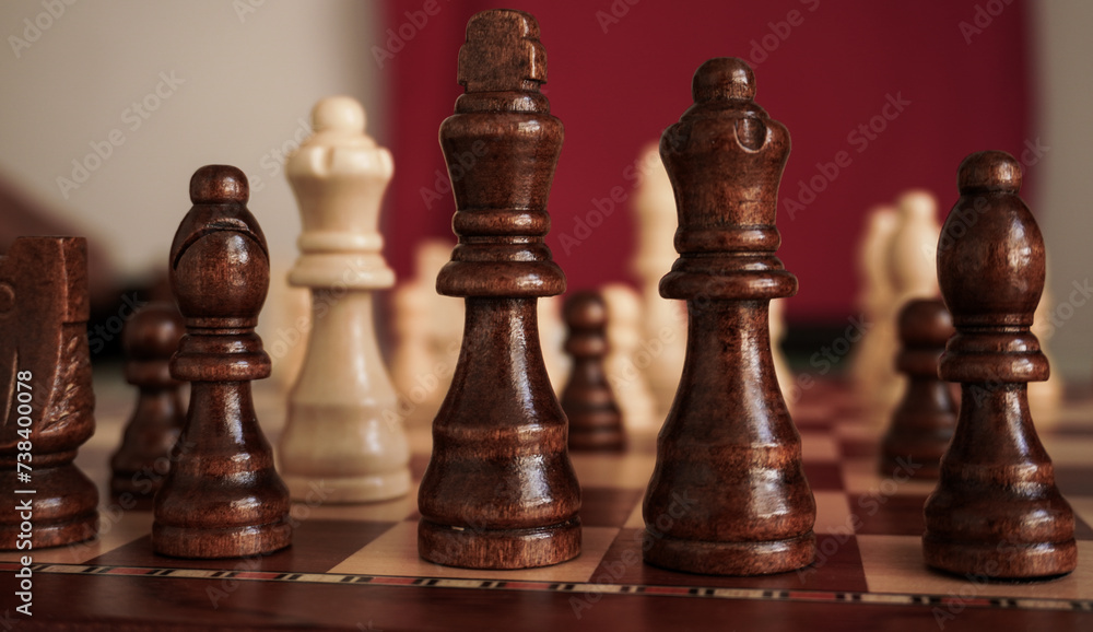 chess pieces on a wooden board in confrontation for the match chess pieces on a wooden board in confrontation for the match
