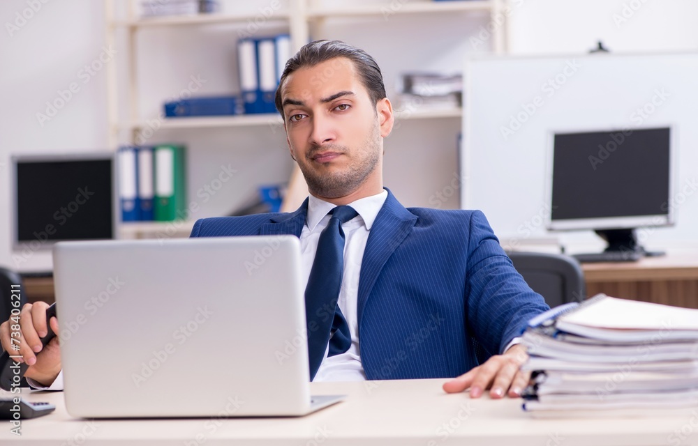 Young male businessman working in the office Young male businessman working in the office