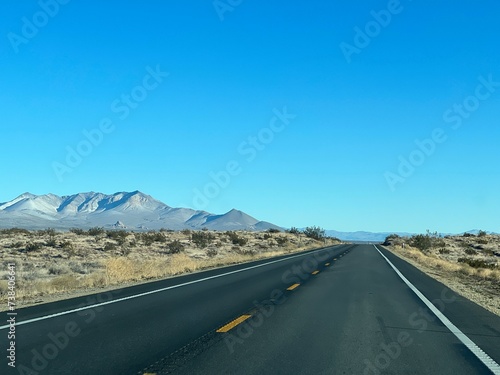 Fresh black tarmac on empty highway through desert and mountains, Red Rock Canyon State Park, near Ridgecrest, California, USA