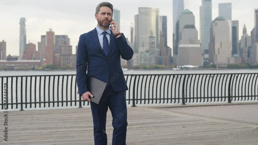 Businessman using mobile and go. Business conversation. Businessman using phone. Man phone conversation in city. Businessman talking on phone. Hispanic business man with phone in Manhattan Businessman using mobile and go. Business conversation. Businessman using phone. Man phone conversation in city. Businessman talking on phone. Hispanic business man with phone in Manhattan