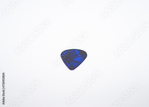 blue colored guitar pick and an abstract design