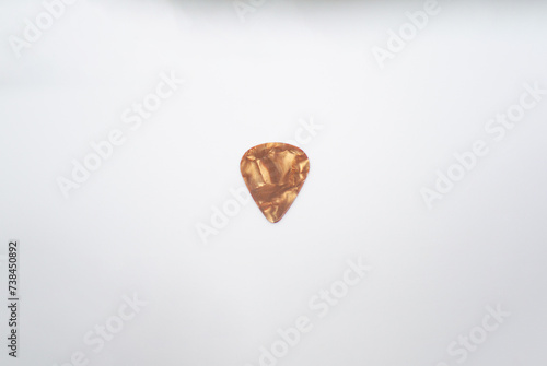 chocolat colored guitar pick and an abstract design