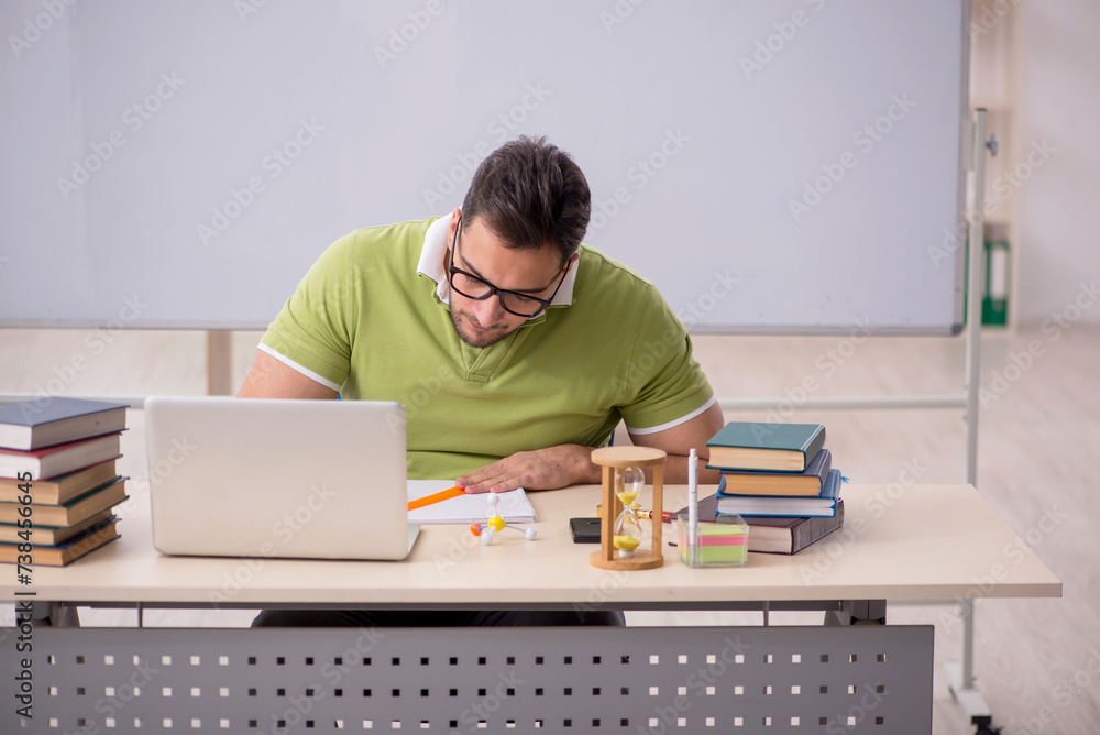 Young male student preparing for exams in the classroom Young male student preparing for exams in the classroom