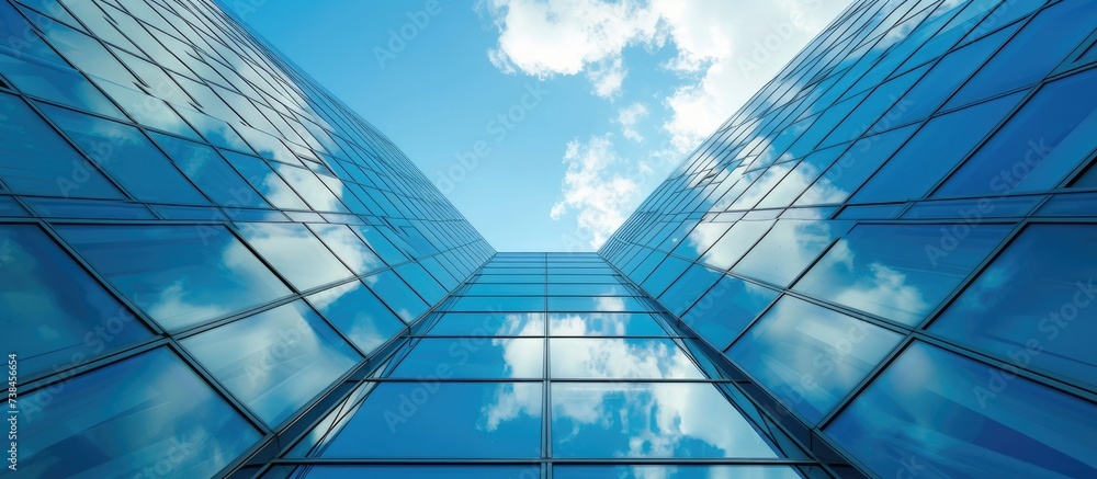 Glass building fragment against blue sky.