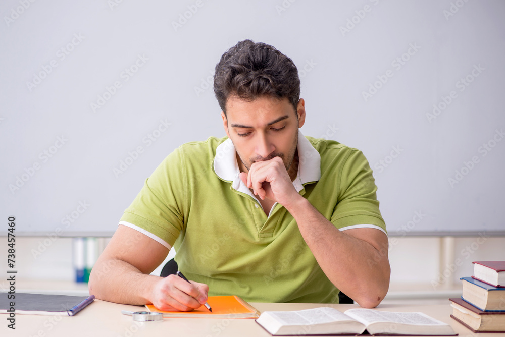 Young male student sitting in the classroom Young male student sitting in the classroom