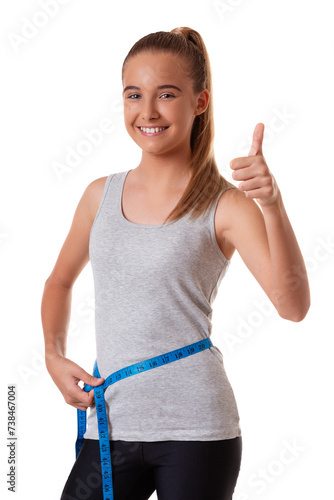 weight loss young girl smiling happy excited standing with measuring tape giving thumbs up success hand sign isolated on white background