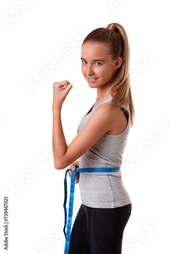 weight loss young girl smiling happy excited standing in profile with measuring tape clenching fist success sign isolated on white background