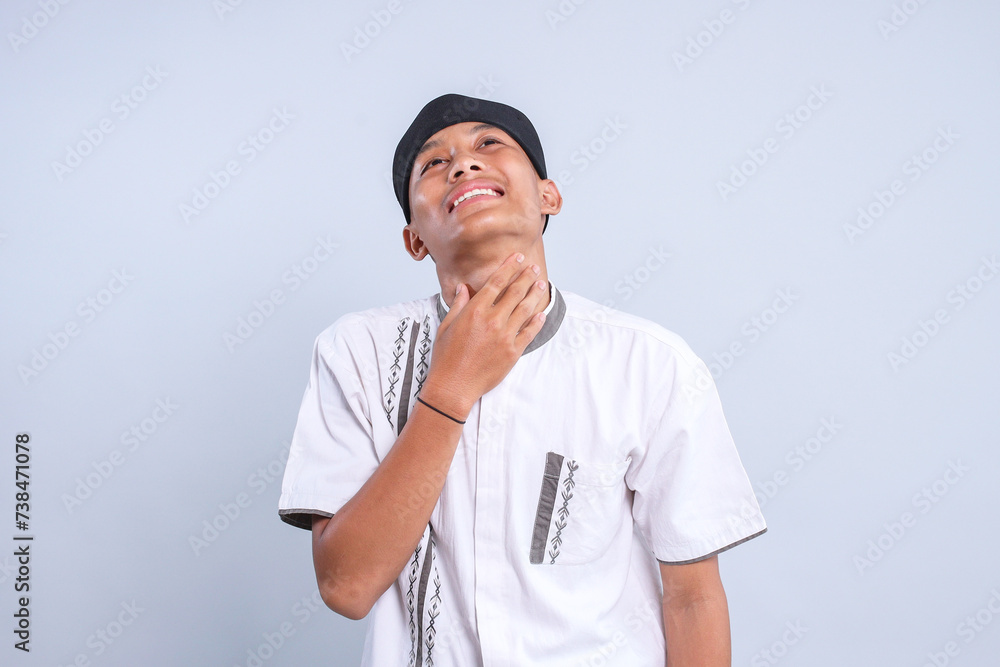Asian Muslim young man touching his throat, feeling thristy during ramadan fasting Asian Muslim young man touching his throat, feeling thristy during ramadan fasting