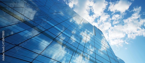 Contemporary glass office buildings reflecting sky and clouds  with sleek exteriors.