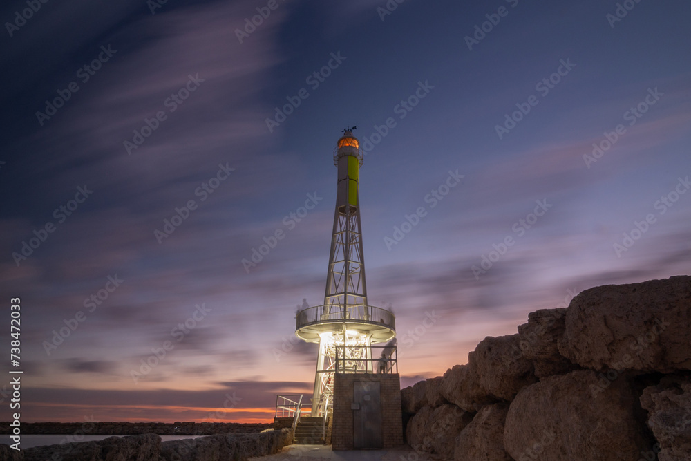 Hillarys lighthouse at Sorento Quay on the rocks, Perth Western Australia, long exposure of clouds, purple, blue, pink sky, rocks, lights