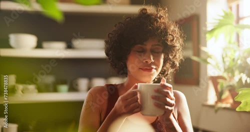 Woman, drinking coffee and daydreaming on morning, calm and relaxing with hot beverage at home. Female person, thinking and peaceful drink or contemplation on weekend, daydream and scent in kitchen photo