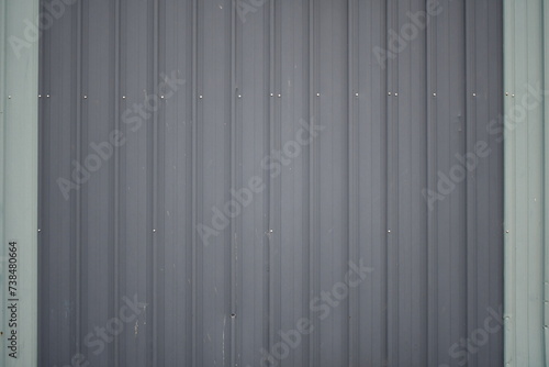 Gray vertical sheet metal siding.