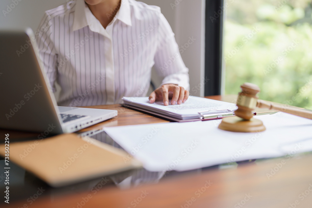 Lawyer woman working on laptop and reading to checking legal agreement of business contract Lawyer woman working on laptop and reading to checking legal agreement of business contract