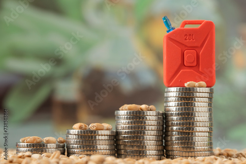Stacks of coins with a canister of gasoline. Concept of rising fuel prices for agricultural machinery