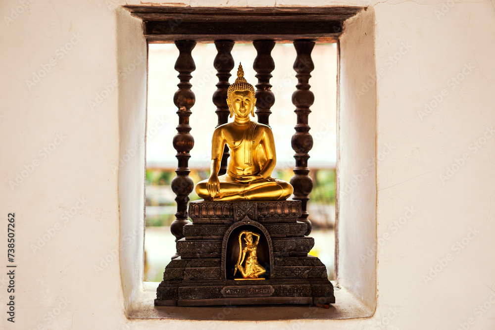Closeup a small golden Buddha statue on wall of the temple. Believe, Culture of Asia, Traditional. Buddhist believe, Calm meditation concept