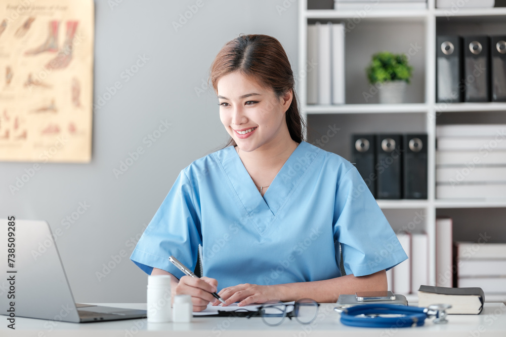 Asian female doctor working on laptop, filling out paperwork, patient medical history, reviewing documents at her workplace medical and health concept Asian female doctor working on laptop, filling out paperwork, patient medical history, reviewing documents at her workplace medical and health concept
