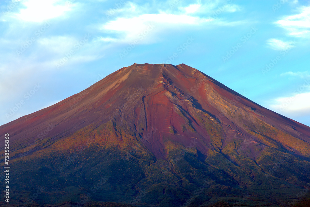 Red Fuji, the sunrise in the autumn, casts a warm, reddish glow on Mount Fuji. The interplay of light and shadow creates an intriguing, grounded effect. A captivating moment that invites wonder.