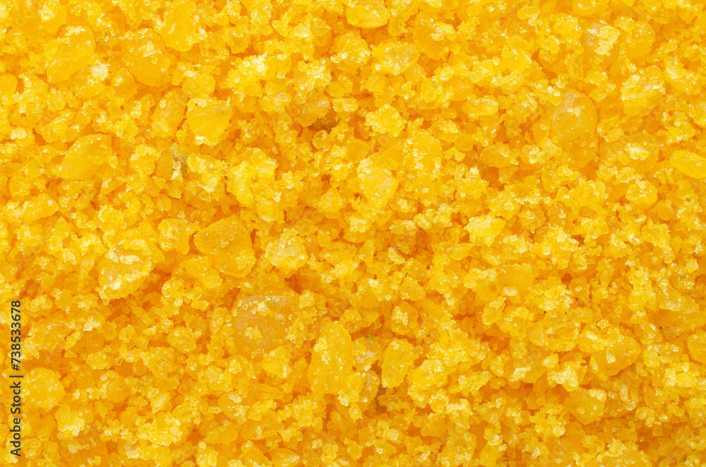 Pile of yellow sea salt background, top view. Aromatic bath salts with mango scent, close-up, for background, top view. The surface is covered with yellow salt crystals as a background. Pile of yellow sea salt background, top view. Aromatic bath salts with mango scent, close-up, for background, top view. The surface is covered with yellow salt crystals as a background.