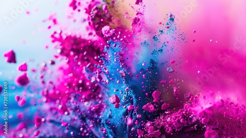 A dynamic explosion of colorful powder against a clear blue sky, symbolizing celebration and joy. © ruchuda