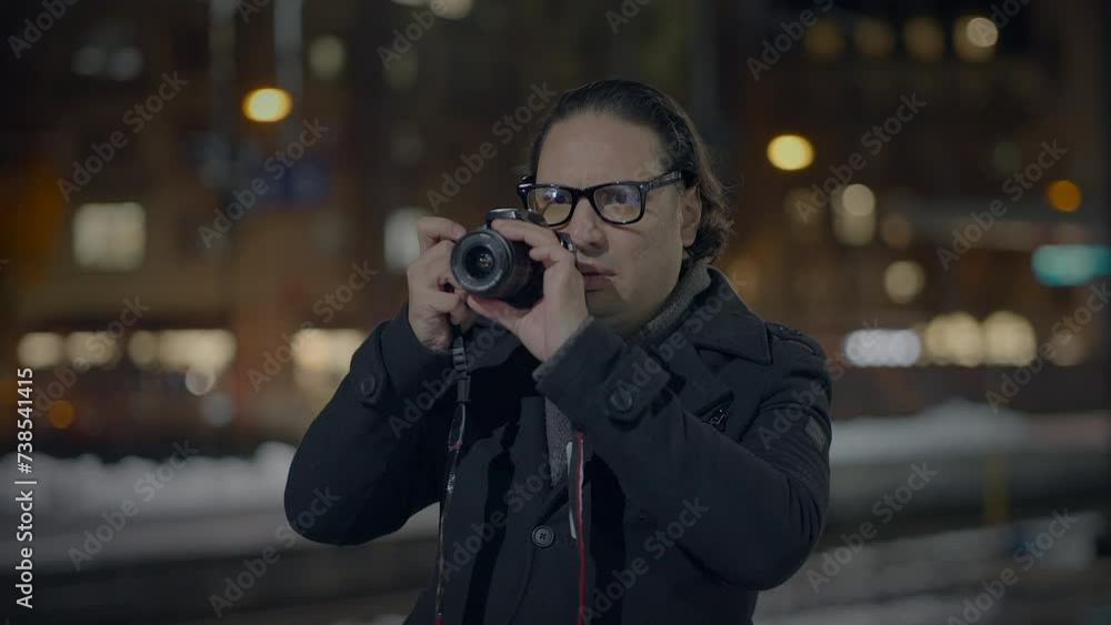 Male Traveler Taking Photo on Crowded Urban City Street at Night Male Traveler Taking Photo on Crowded Urban City Street at Night