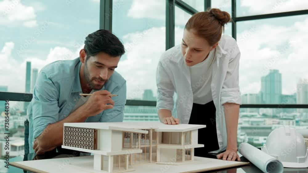 Cooperative architect engineer team working together to measure house ...