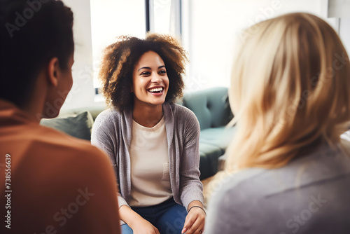 Smiling african american woman talking with psychologist during therapy session