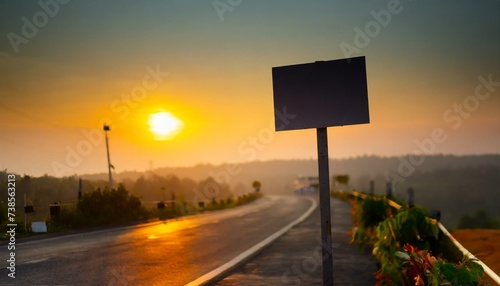 Blank bill board beside highway background sun set view