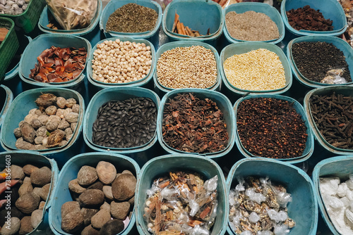 A closeup view of many types of herbs, placed on tray with square and rectangle shape. Traditional Indonesian medicine concept