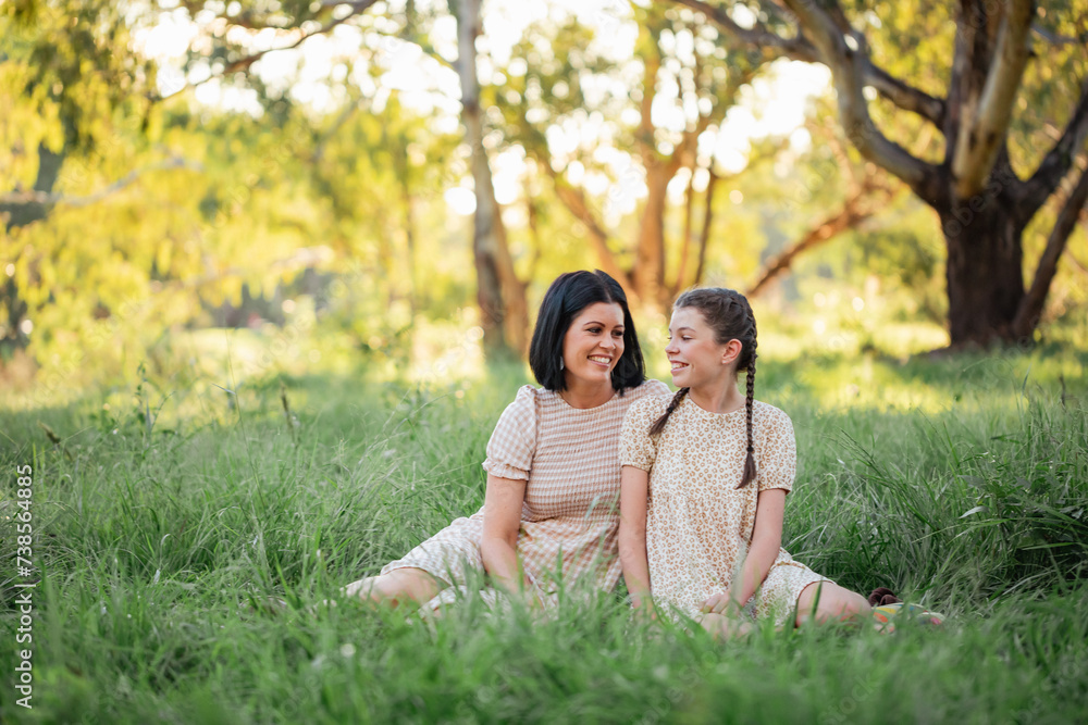 Mother and daughter sitting together in natural Australian bush setting Mother and daughter sitting together in natural Australian bush setting
