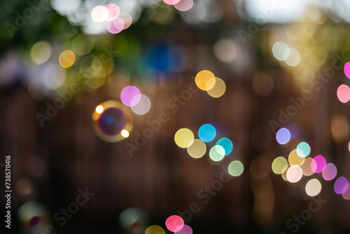 Soft focus background image of bubbles floating in golden morning sunlight photo