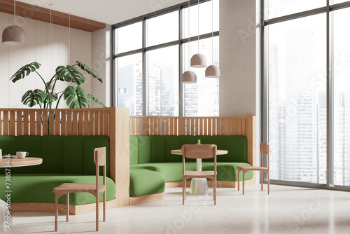 Stylish cafe interior with chairs and sofa in row near panoramic window
