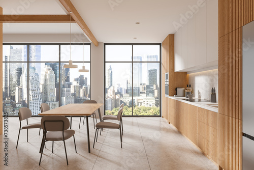 Modern home kitchen interior with cabinet and eating table, panoramic window © ImageFlow
