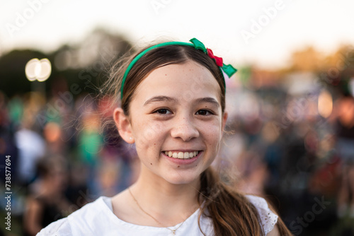 tween girl smiling at a community event with a Christmas hairband photo