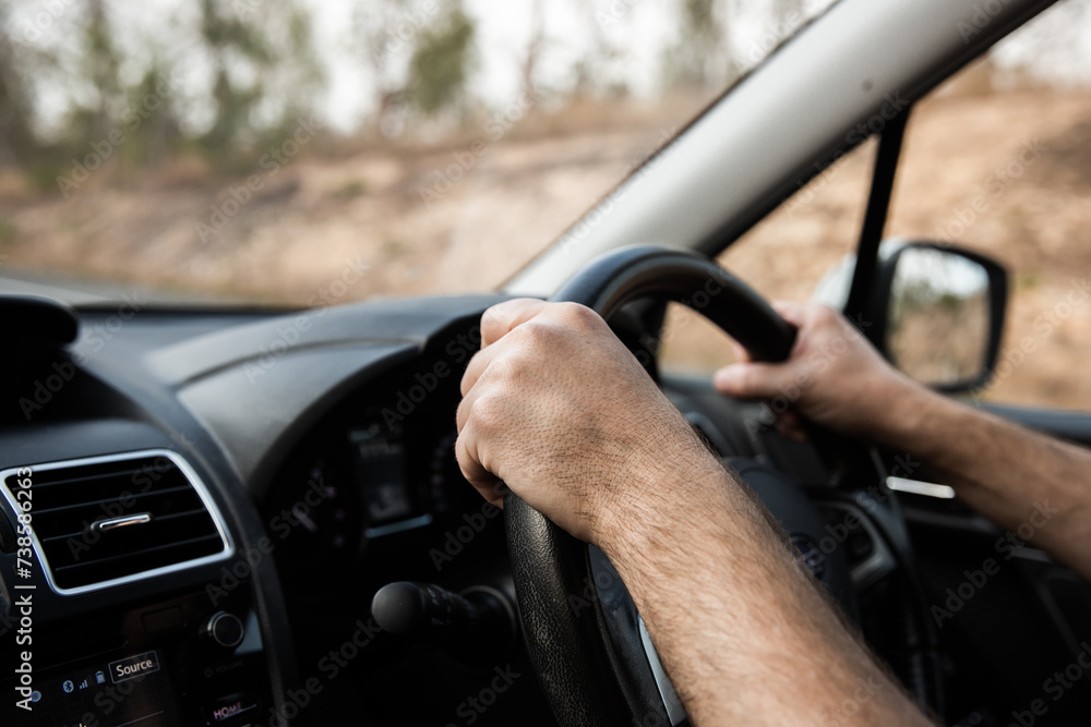hands on a steering wheel on a highway drive hands on a steering wheel on a highway drive